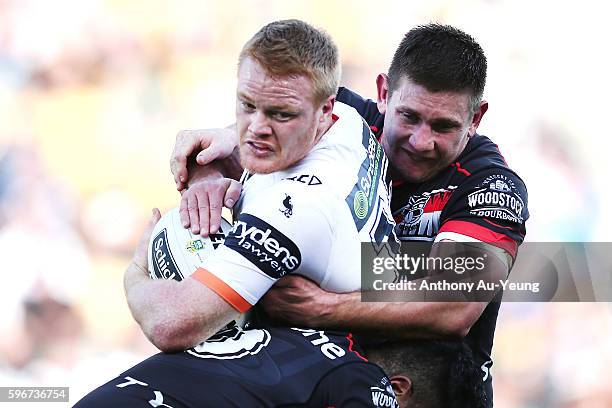 Joel Edwards of the Tigers is tackled by Jacob Lillyman of the Warriors during the round 25 NRL match between the New Zealand Warriors and the Wests...