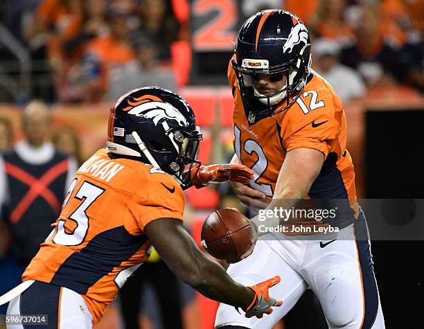 Denver Broncos quarterback Paxton Lynch hands off to Denver Broncos running back Ronnie Hillman during the fourth quarter against the Los Angeles...