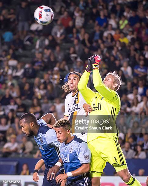 August 27: Alan Gordon of Los Angeles Galaxy battles David Ousted, Kendall Waston and Masato Kudo of Vancouver Whitecaps during Los Angeles Galaxy's...