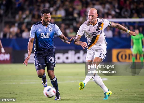 August 27: Jelle Van Damme of Los Angeles Galaxy and Giles Barnes of Vancouver Whitecaps during Los Angeles Galaxy's MLS match against Vancouver...