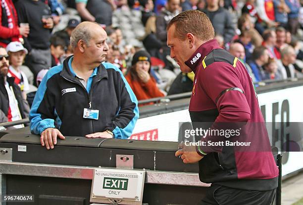 Lions head coach Justin Leppitsch heads to the exit after speaking to his players during the round 23 AFL match between the St Kilda Saints and the...