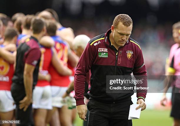 Lions head coach Justin Leppitsch leaves the field after speaking to his team for the last time during the round 23 AFL match between the St Kilda...