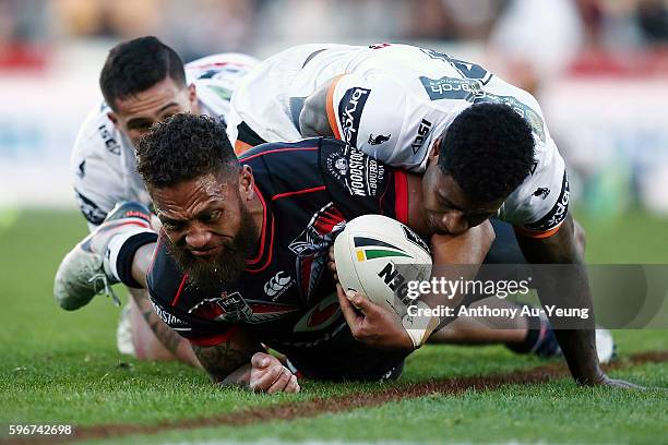 Manu Vatuvei of the Warriors is tackled by Kevin Naiqama of the Tigers during the round 25 NRL match between the New Zealand Warriors and the Wests...