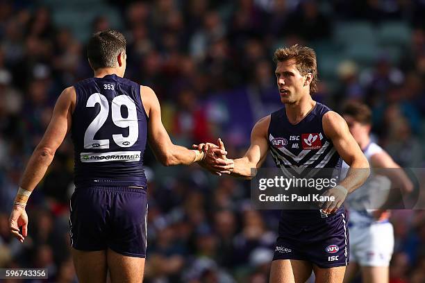 Matthew Pavlich and Matt de Boer of the Dockers celebrate a goal during the round 23 AFL match between the Fremantle Dockers and the Western Bulldogs...