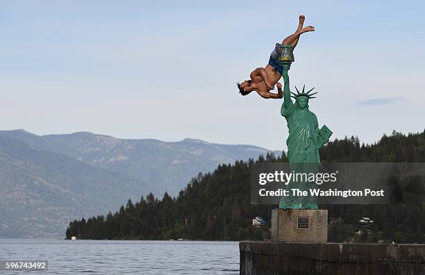 Jacob Clad flips into Lake Pend Oreille from a replica of the Statue of Liberty on Wednesday June 22, 2016 in Sandpoint, ID. Northern Idaho and the...