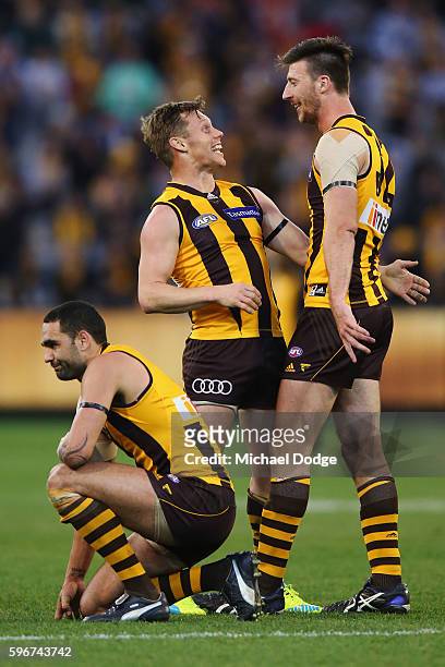 Jack Fitzpatrick of the Hawks celebrates the win with Shaun Burgoyne and Sam Mitchell during the round 23 AFL match between the Hawthorn Hawks and...
