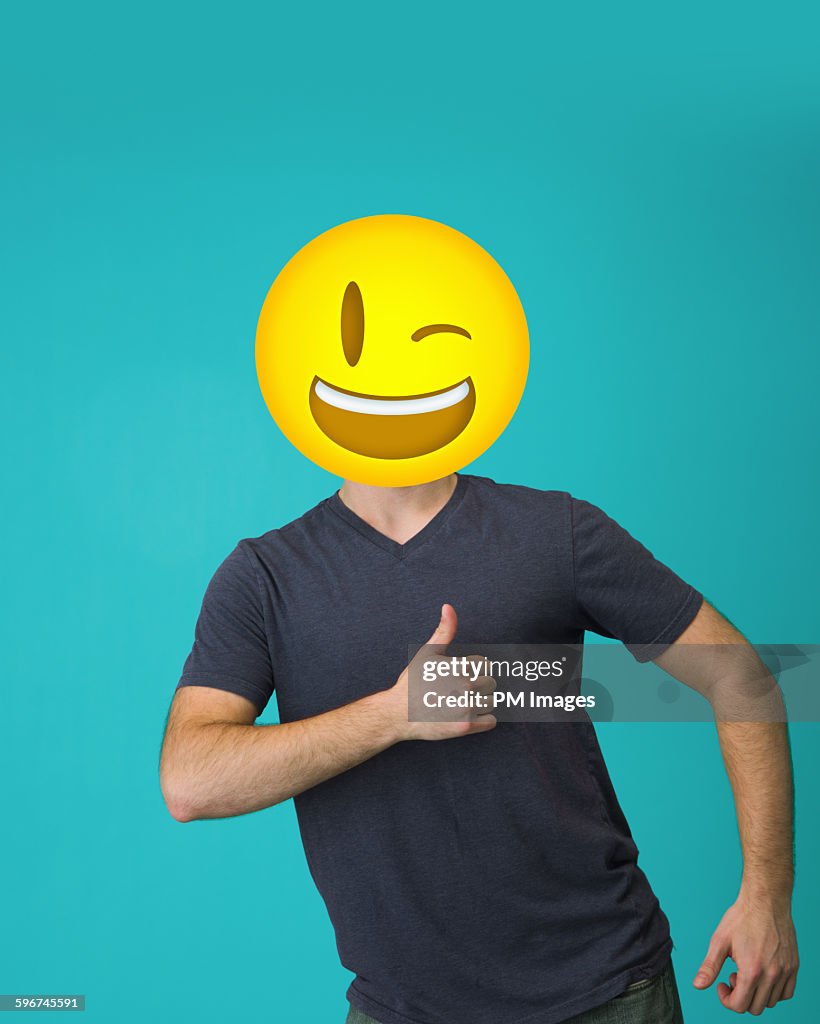 Man with winking emoji head