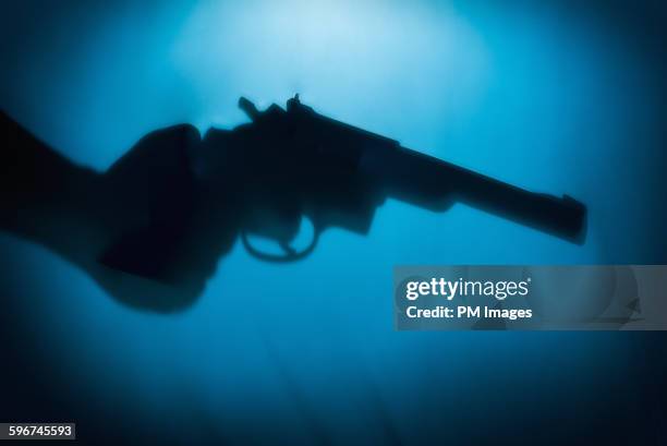 hand holding handgun - pistol stockfoto's en -beelden