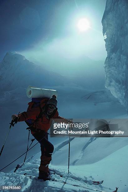 Mountaineer traverses the frozen slopes of the Karakoram Range on skis. Pakistan.