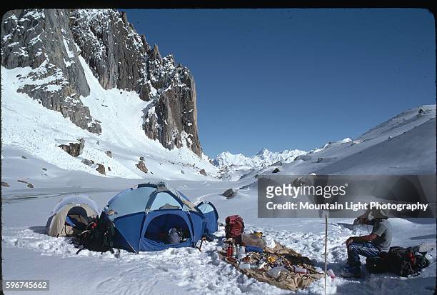 Mountaineer rests at a camp among the frozen peaks of the Himalayas. Pakistan.