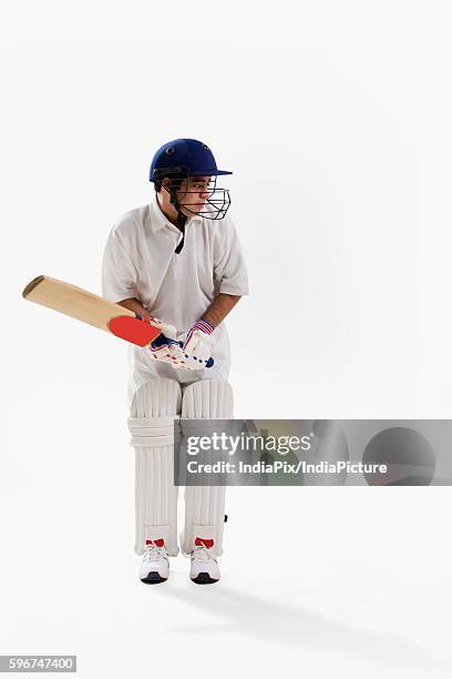 young man playing cricket isolated over white background - padding stock pictures, royalty-free photos & images
