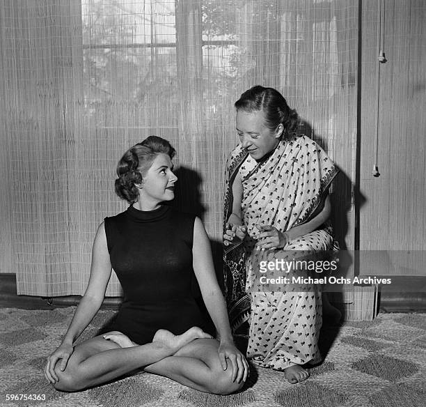 Yogi Indra Devi instructs a student on a yoga position in her studio in Hollywood,California.