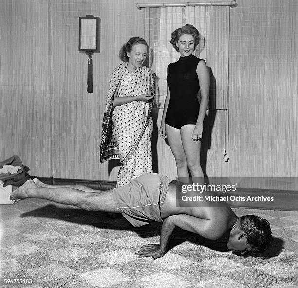 Yogi Indra Devi instructs a student on a yoga position in her studio in Hollywood,California.