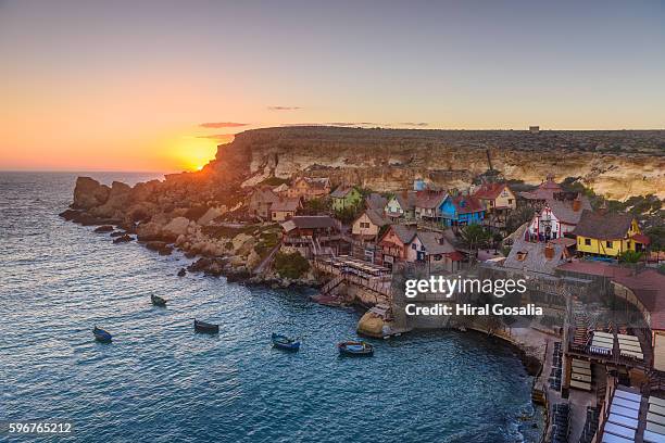 sunset at popeye village - mellieha malta stock pictures, royalty-free photos & images