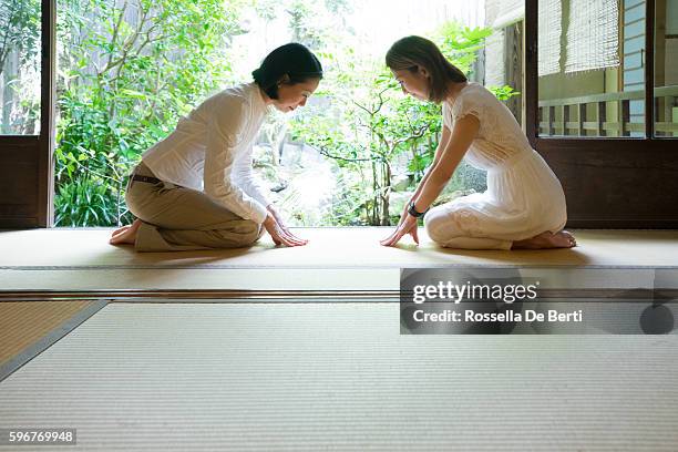 two japanese women bowing with respect - woman bowing stock pictures, royalty-free photos & images