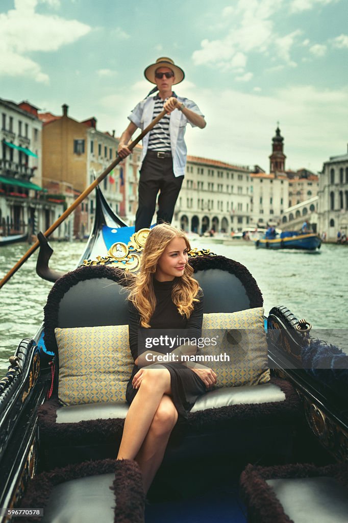 Young woman in gondola tour in Venice