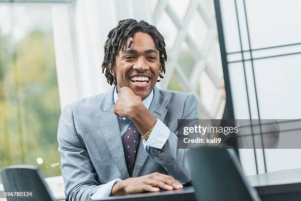 young black businessman with dreadlocks - hand on chin stock pictures, royalty-free photos & images