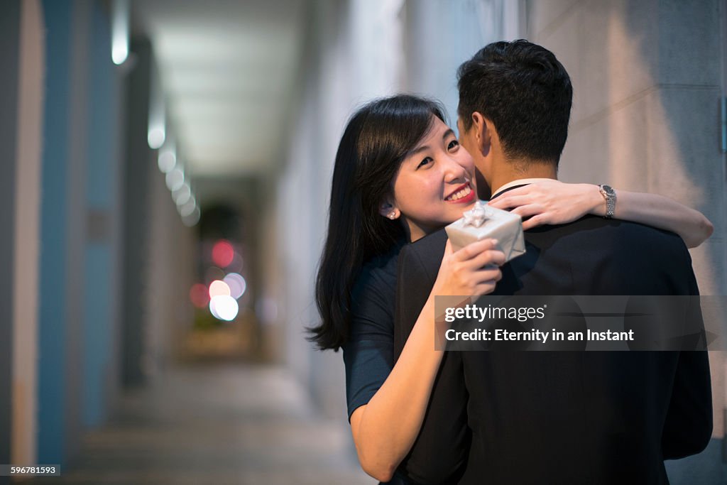 Young couple hugging at night.