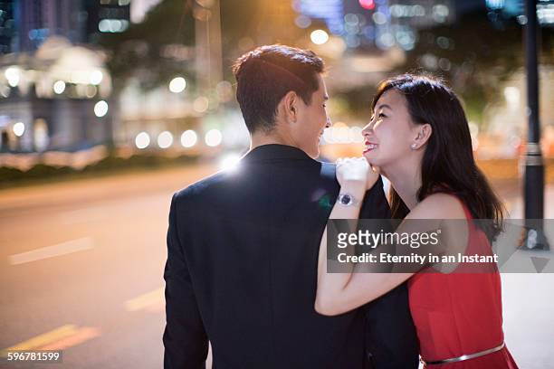 young couple hugging each other at night. - obama meets with minister mentor of singapore stockfoto's en -beelden