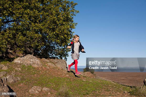 seven year old girl running down rocky hill - san pablo bay ストックフォトと画像