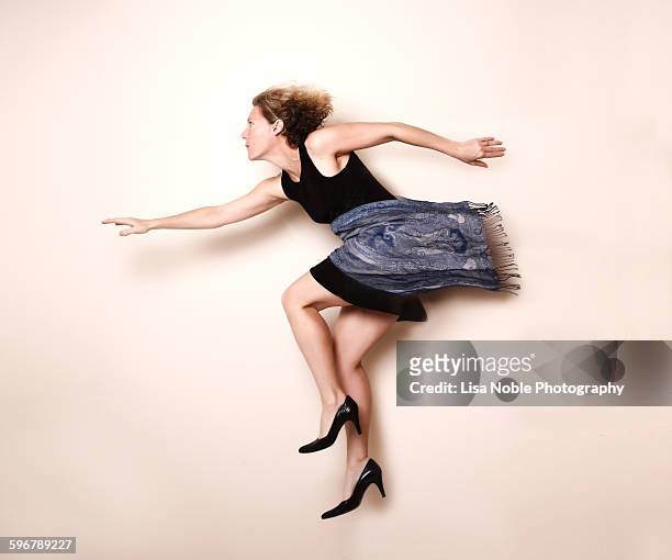 woman in black dress and heels - rebirth stock-fotos und bilder