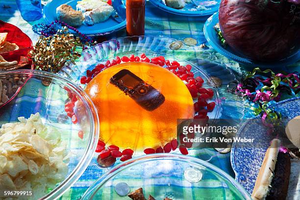 cell phone suspended in jello mould on party table - gelatin mold fotografías e imágenes de stock