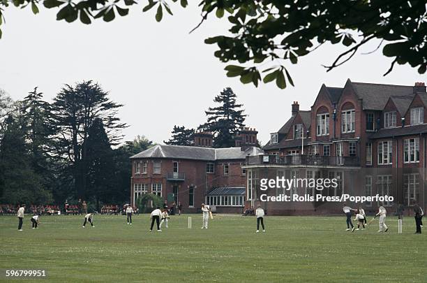 View of pupils of Heatherdown Prep School playing a game of cricket on a pitch in front of the school buildings near Ascot in 1968. Prince Andrew...