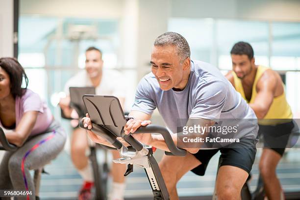 cycling class at the gym - sports training stock pictures, royalty-free photos & images