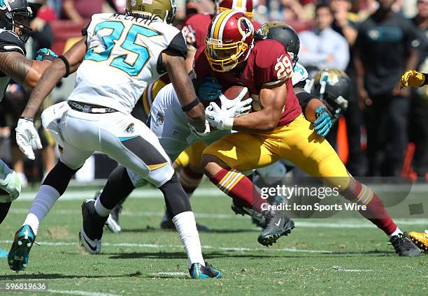 Washington Redskins running back Roy Helu runs by Jacksonville Jaguars cornerback Demetrius McCray during a match between the Washington Redskins and...