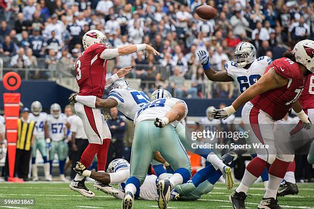 Dallas Cowboys defensive end DeMarcus Lawrence and Dallas Cowboys linebacker Anthony Hitchens hit Arizona Cardinals quarterback Carson Palmer as he...