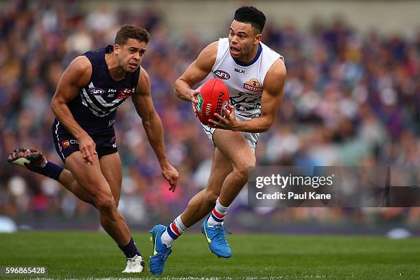 Jason Johannisen of the Bulldogs breaks clear of Stephen Hill of the Dockers during the round 23 AFL match between the Fremantle Dockers and the...