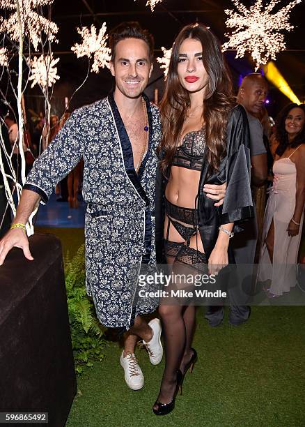 Designer Mike Appel and Iana Cornescu attend the annual Midsummer Night's Dream party hosted by Hugh Hefner at The Playboy Mansion on August 27, 2016...