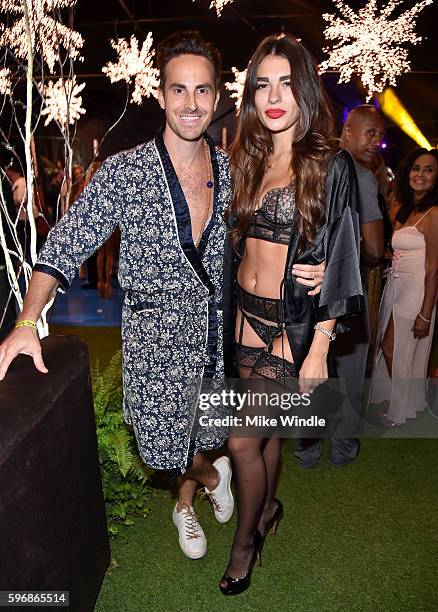 Designer Mike Appel and Iana Cornescu attend the annual Midsummer Night's Dream party hosted by Hugh Hefner at The Playboy Mansion on August 27, 2016...