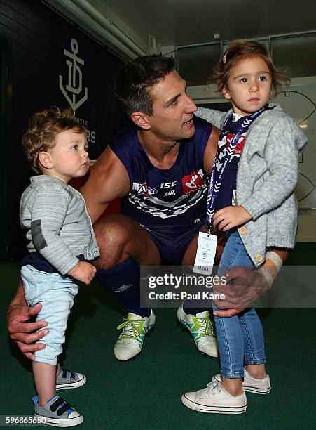 Matthew Pavlich of the Dockers shares a moment with his children Jack and Harper after playing his final game during the round 23 AFL match between...
