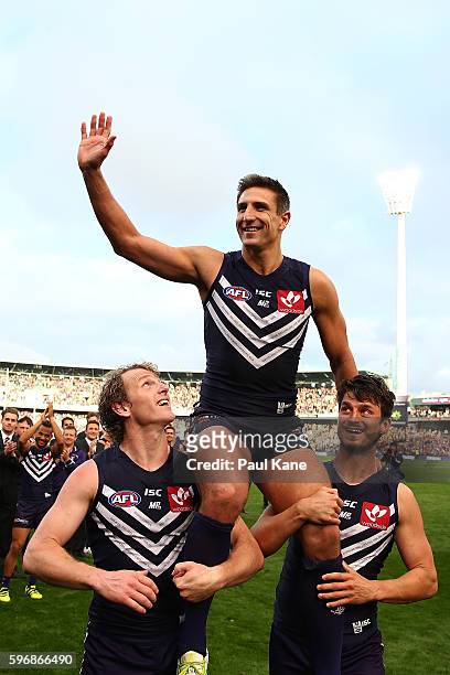 Matthew Pavlich of the Dockers is chaired from the ground by David Mundy and Alex Silvagni after playing his 353rd and final game during the round 23...