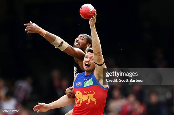 Jason Holmes of the Saints and Stefan Martin of the Lions compete for the ball during the round 23 AFL match between the St Kilda Saints and the...