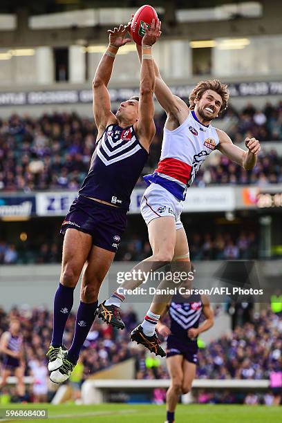 Matthew Pavlich of the Dockers contests a mark agains Joel Hamling of the Bulldogs during the 2016 AFL Round 23 match between the Fremantle Dockers...