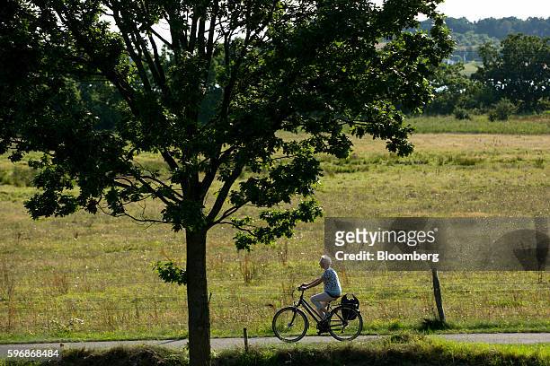 Cyclists rides along a path in Sellin, Ruegen Island, Germany, on Saturday, Aug. 27, 2016. Germany's Bundesbank said raising the legal retirement age...