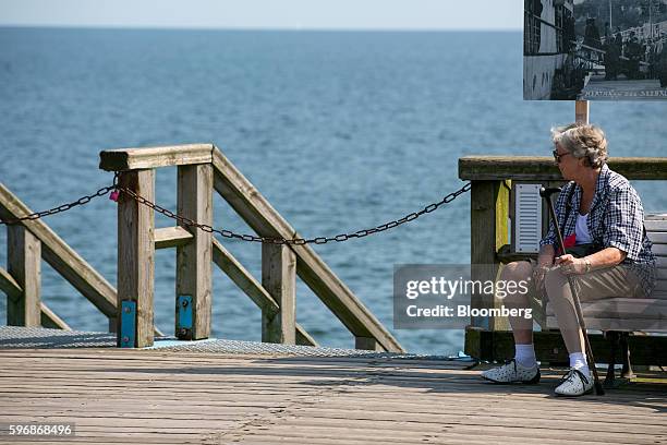 Pensioner rests on a bench by the seafront in Sellin, Ruegen Island, Germany, on Saturday, Aug. 27, 2016. Germany's Bundesbank said raising the legal...