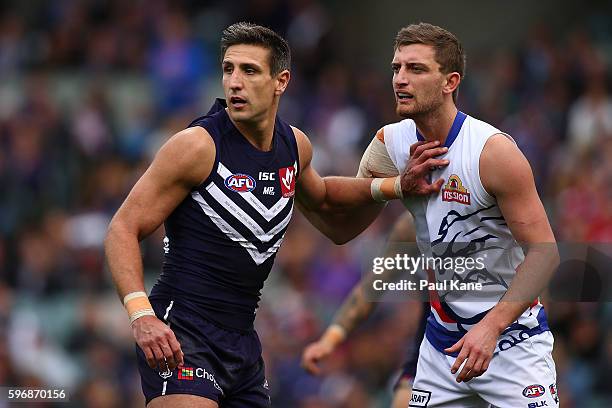 Matthew Pavlich of the Dockers holds off Fletcher Roberts of the Bulldogs during the round 23 AFL match between the Fremantle Dockers and the Western...