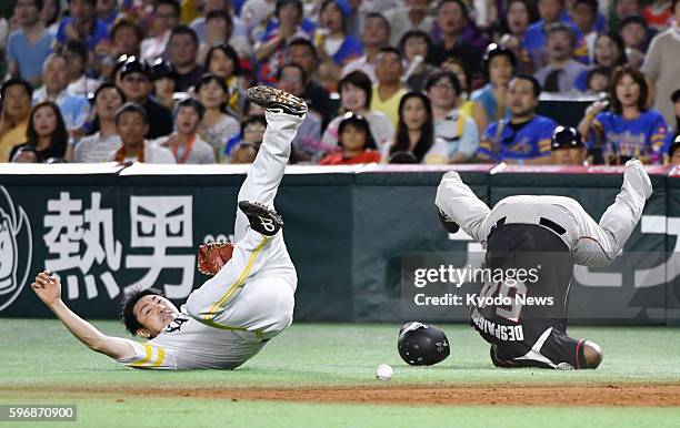 SoftBank Hawks first baseman Seiichi Uchikawa gets injured in a collision with Alfredo Despaigne of the Lotte Marines in the eighth inning of a...