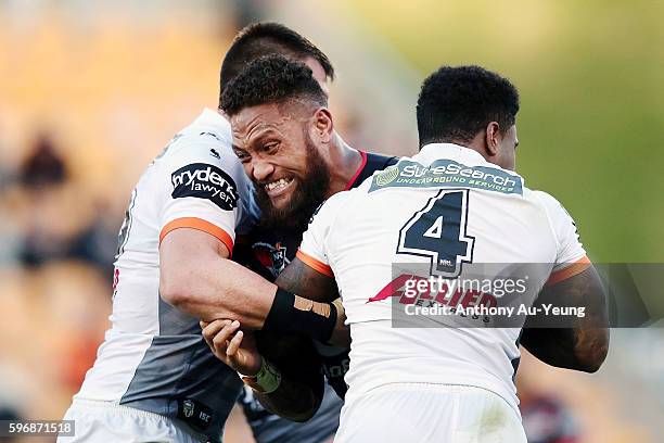 Manu Vatuvei of the Warriors charges into Kevin Naiqama of the Tigers during the round 25 NRL match between the New Zealand Warriors and the Wests...