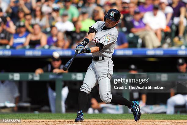 Ichiro Suzuki of the Miami Marlins hits a triple off Chris Rusin of the Colorado Rockies for the 3,000th hit of his major league career in the...