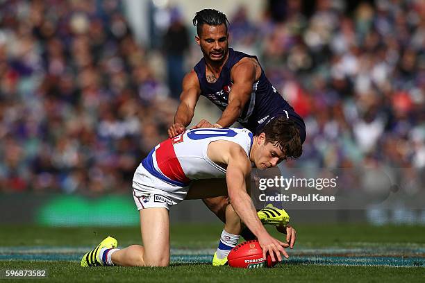 Josh Dunkley of the Bulldogs and Danyle Pearce of the Dockers contest for the ball during the round 23 AFL match between the Fremantle Dockers and...