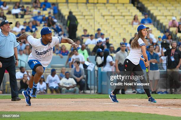 King Bach runs for Amanda Cerny at the Hollywood Stars game at Dodger Stadium on August 27, 2016 in Los Angeles, California.
