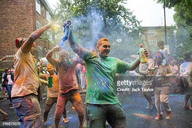 Revellers dance and throw powder paint at the Notting Hill Carnival on August 28, 2016 in London, England. The Notting Hill Carnival, which has taken...