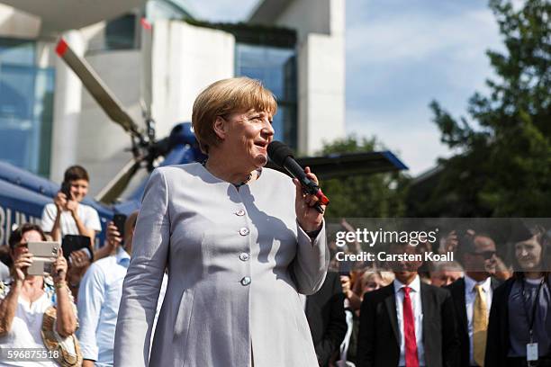 German Chancellor Angela Merkel speaks to members of the public who had come for the annual open-house day at the Chancellery on August 28, 2016 in...