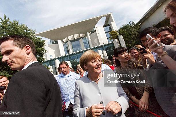 German Chancellor Angela Merkel greets members of the public who had come for the annual open-house day at the Chancellery on August 28, 2016 in...