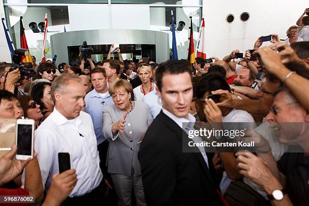 German Chancellor Angela Merkel greets members of the public who had come for the annual open-house day at the Chancellery on August 28, 2016 in...