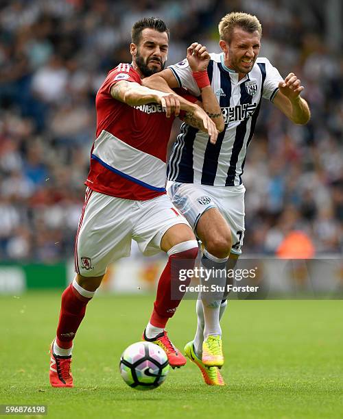 Alvaro Negredo of Middlesbrough challenges for the ball with Gareth McAuley of West Bromwich Albion during the Premier League match between West...